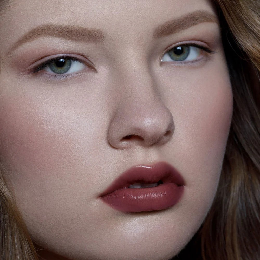 Close-up of a person's face with a focus on the lips. RITUEL DE FILLE Color Nectar Pigment Balm Weeping Cherry