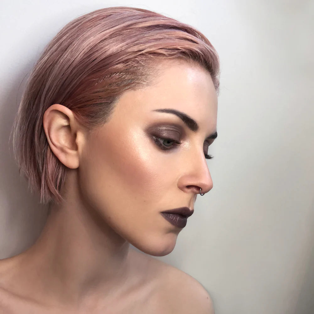 Woman with short, styled hair against a neutral background. RITUEL DE FILLE Enchanted Lip Sheer Black Locust