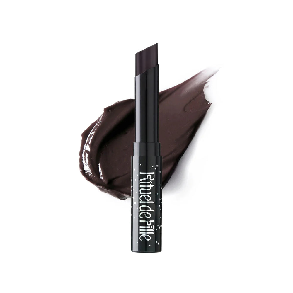 Rituel de Fille Enchanted Lip Sheer in Black Locust, a semi-matte dark vampy lipstick with sleek black star-dusted tube packaging.