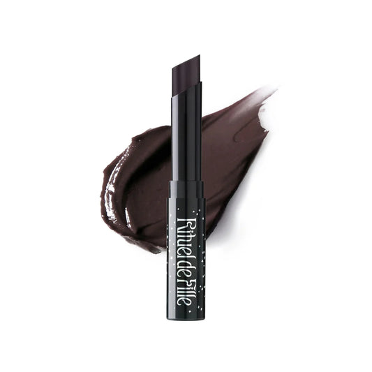 Rituel de Fille Enchanted Lip Sheer in Black Locust, a semi-matte dark vampy lipstick with sleek black star-dusted tube packaging.