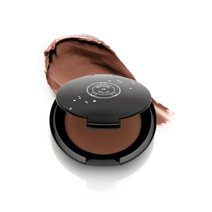 RITUEL DE FILLE Inner Glow Crème Pigment in Eros, a rosy sandy beige cream pigment in a sleek starry black compact.
