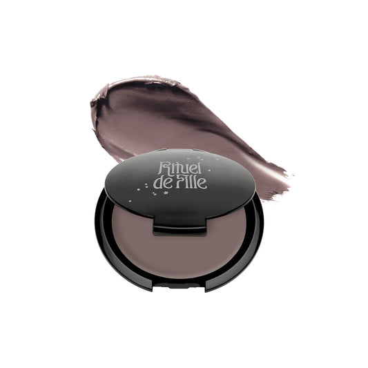 RITUEL DE FILLE Inner Glow Crème Pigment in Intuition, a soft gray taupe-mauve cream pigment housed in a starry black compact.