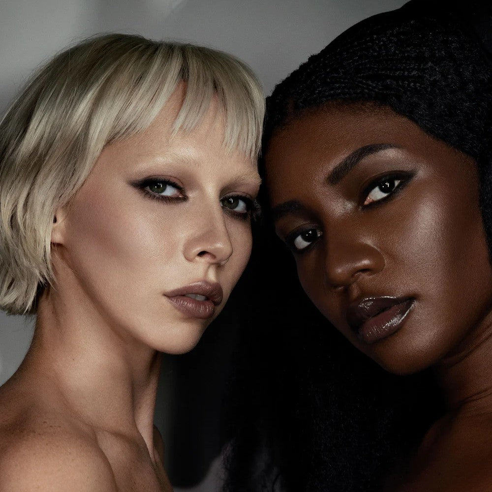 Two women with different skin tones and hairstyles posing close together. RITUEL DE FILLE Inner Glow Crème Pigment Omen
