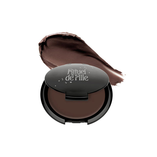 RITUEL DE FILLE Inner Glow Crème Pigment in Omen, a cool-toned taupe cream pigment housed in a starry black compact.