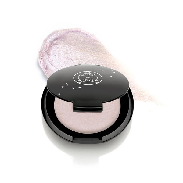 Rituel de Fille Rare Light Crème Luminizer in Ghost Light, cool pale pink with violet-blue shift in compact.