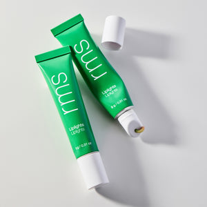 Two green tubes of RMS Beauty lip balm on a light gray background. RMS BEAUTY Liplights Cream Lip Gloss Chameleon