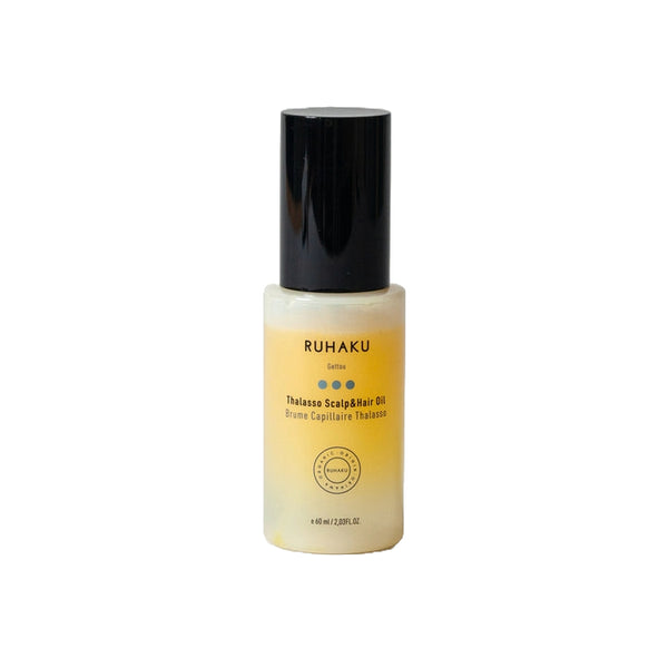 A bottle of Ruhaku Thelasse ScalpHair Oil with a black cap and a frosted glass body showing the golden-yellow oil inside, set against a plain white background.