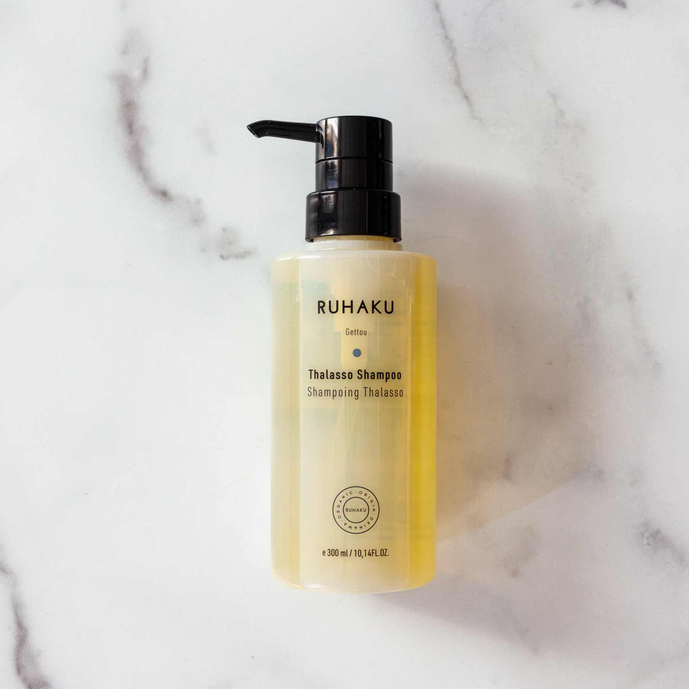 A 300 ml bottle of Ruhaku Thalasso Shampoo with a black pump dispenser, showing the yellow-colored shampoo inside, on a plain white background.