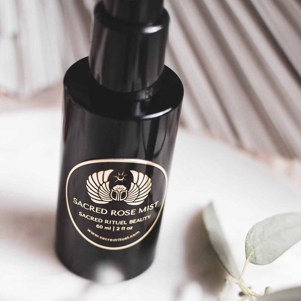 Sacred Rituel Sacred Rose Mist in a violet Miron glass spray bottle, a hydrating botanical rose water mist.