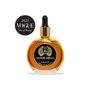 Glass bottle of Sacred Rituel Sacred Serum face oil, featuring a golden botanical blend made with organic plant oils and extracts for a radiant appearance. 50 ml dropper