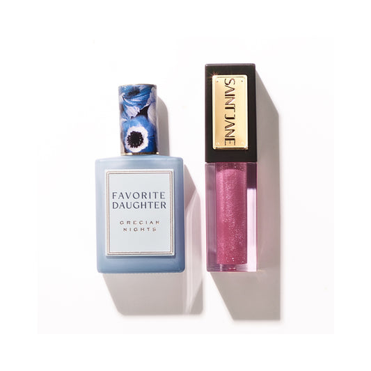 SAINT JANE x Favorite Daughter Lip and Fragrance Oil Duo in a reusable floral keepsake box, featuring a sheer berry Luxury Lip Oil and Grecian Nights fragrance with notes of waterlily, gardenia, and nectar. Limited edition beauty gift set.