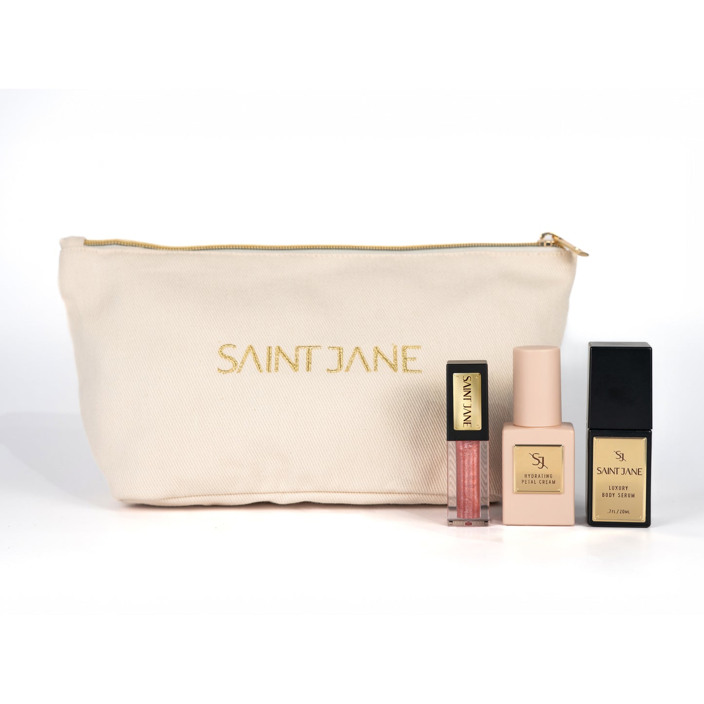 SAINT JANE Little Luxuries Holiday Glow Set with deluxe Hydrating Petal Cream, Luxury Body Serum, Luxury Lip Oil in Alchemy, and a gold makeup bag.