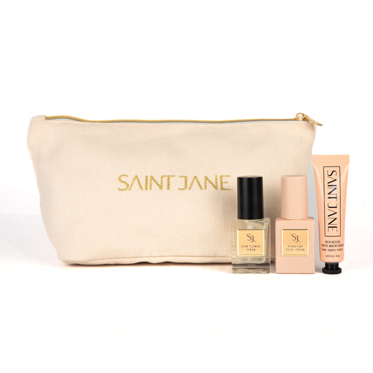 SAINT JANE Holiday Mini Set with Star Flower Serum, Hydrating Petal Cream, Rich Rescue Mucin Cream, and a gold makeup bag.