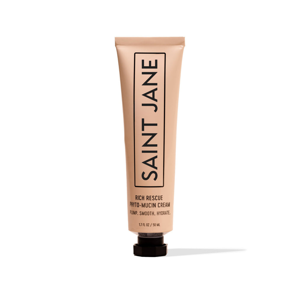 A squeeze tube of Saint Jane Rich Rescue Phyto-Mucin Cream on a clean white background. The tube is a warm beige color with black text and a black cap.