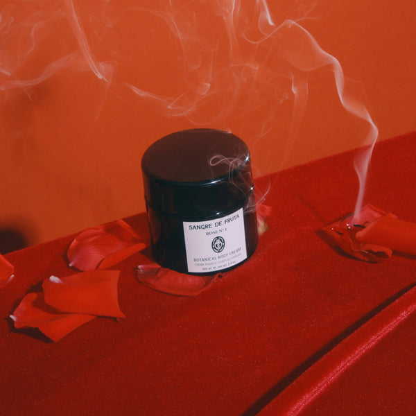 Black jar with a label on a red surface with smoke effect