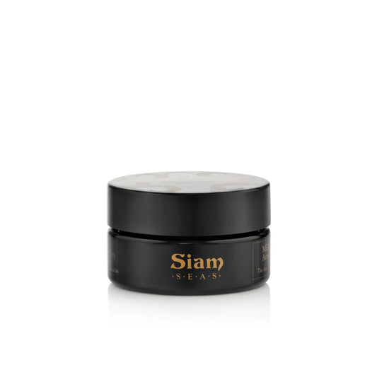 A black jar of Siam Seas Mekha exfoliating cleanser with bamboo and jojoba beads for smooth, radiant skin on white background