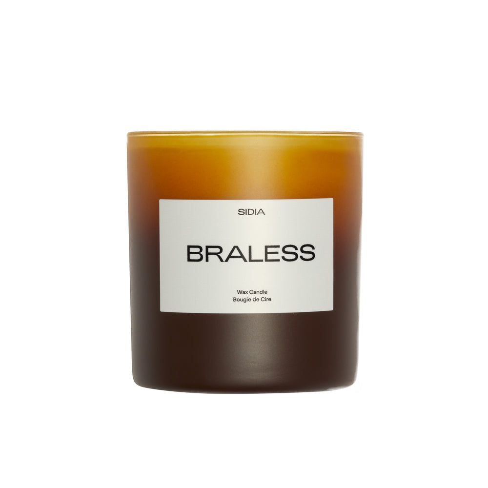 A SIDA Braless scented wax candle in a frosted amber glass jar with a white label, set against a plain white background.