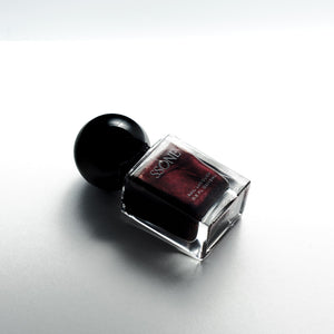 Nail polish bottle with black cap on a white background