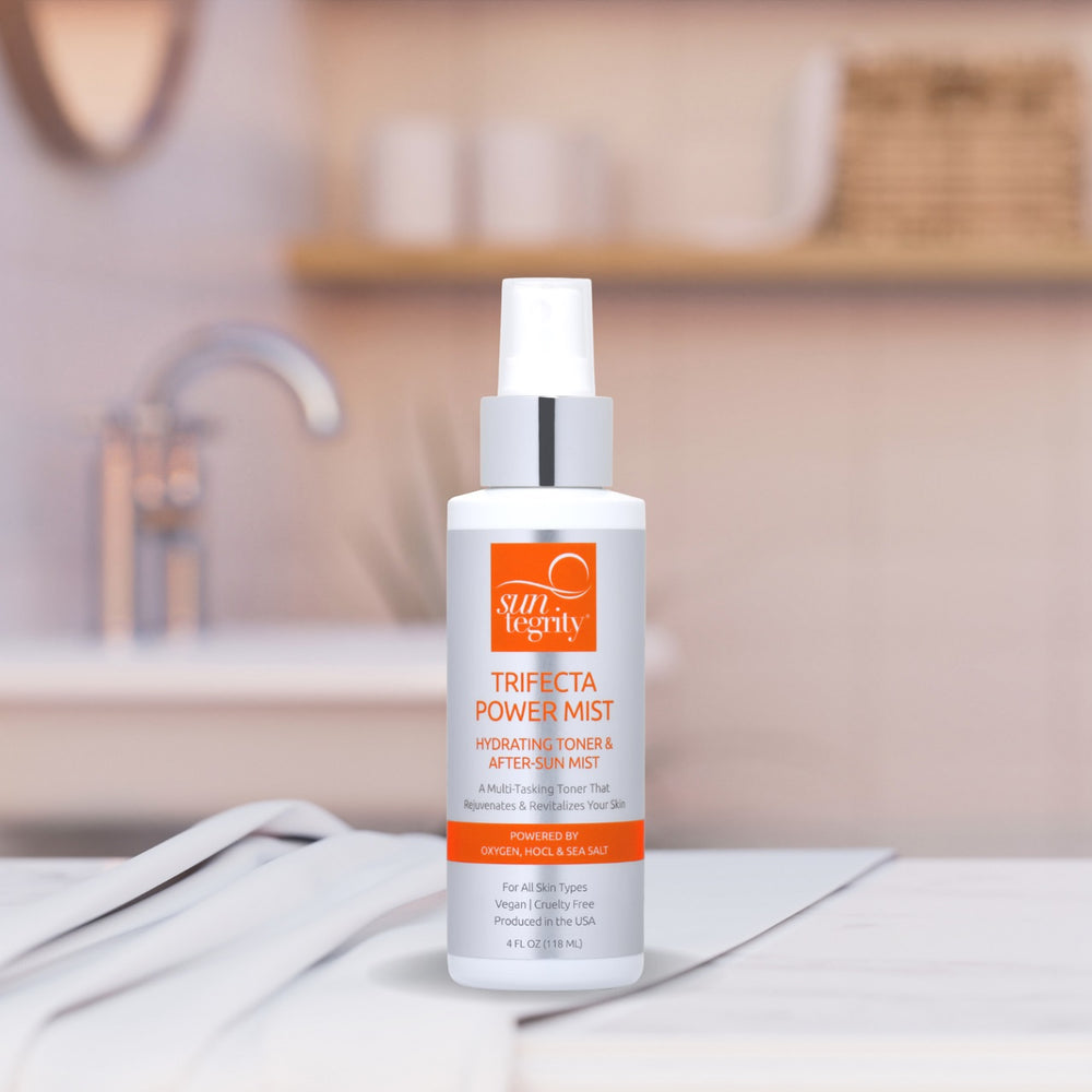 A bottle of SUNTEGRITY Trifecta Power Mist, a multi-tasking skin mist with Oxygen, HOCL, and Sea Salt, designed to soothe, hydrate, and support the skin. Suitable for all skin types, it can be used as a toner, post-workout mist, and after-sun spray. Vegan, cruelty-free, and free from harsh chemicals