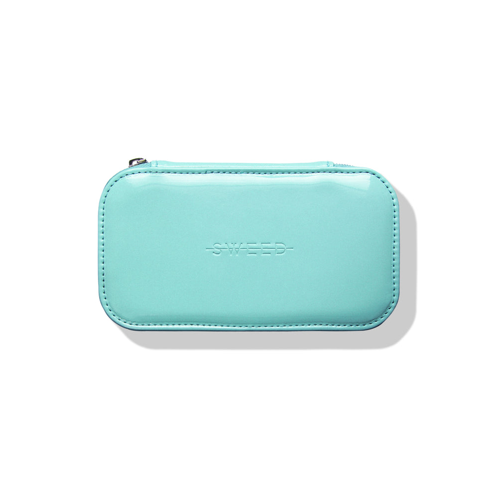 SWEED The Makeup Bag in signature blue, designed for travel and everyday use. Compact size with a protective pocket for small items. Made from sleek, easy-to-clean vegan materials.