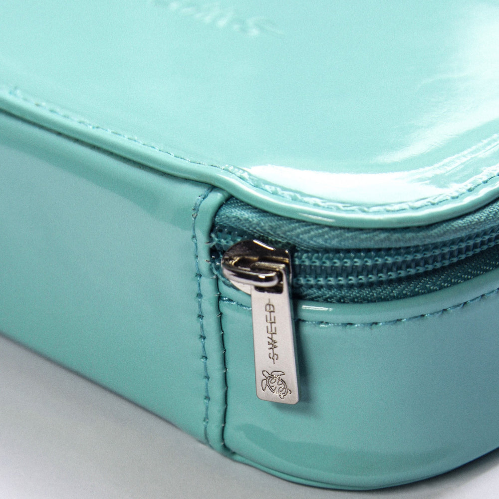 SWEED The Makeup Bag in signature blue, designed for travel and everyday use. Compact size with a protective pocket for small items. Made from sleek, easy-to-clean vegan materials.