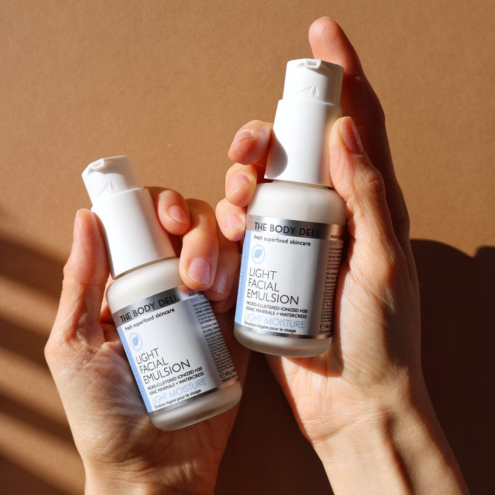 THE BODY DELI LIGHT Facial Emulsion bottle with white pump  on a white background.