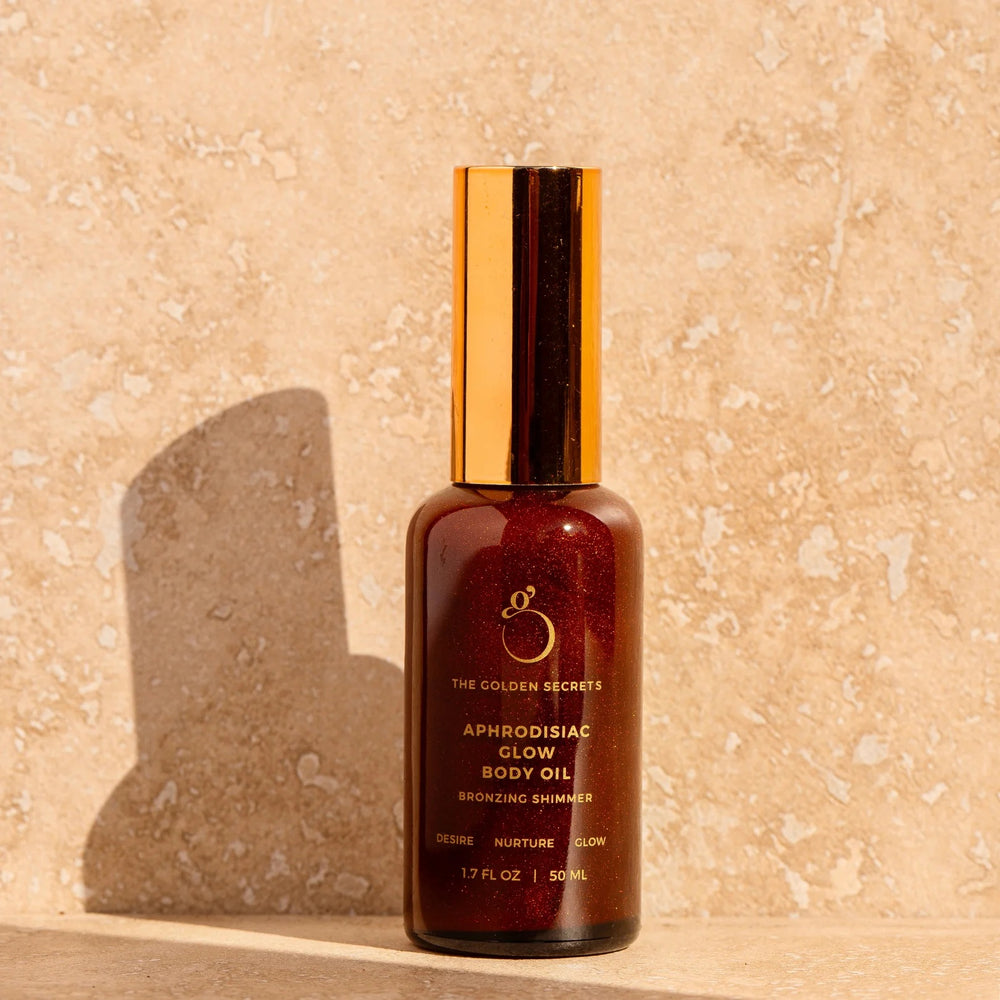 The Golden Secrets Aphrodisiac Glow Oil, a nourishing bronzing body oil that deeply hydrates and enhances your natural glow with a subtle tint. Featuring a blend of jasmine, mandarin, coconut oil, and golden mica, this high vibrational oil nourishes and smooths the skin, leaving a radiant appearance. Perfect for use on the body, face, and hair, it provides a luminous golden glow without DHA or synthetic fragrance. Think Dirty Verified, this versatile oil hydrates and nourishes for a youthful, balanced look.
