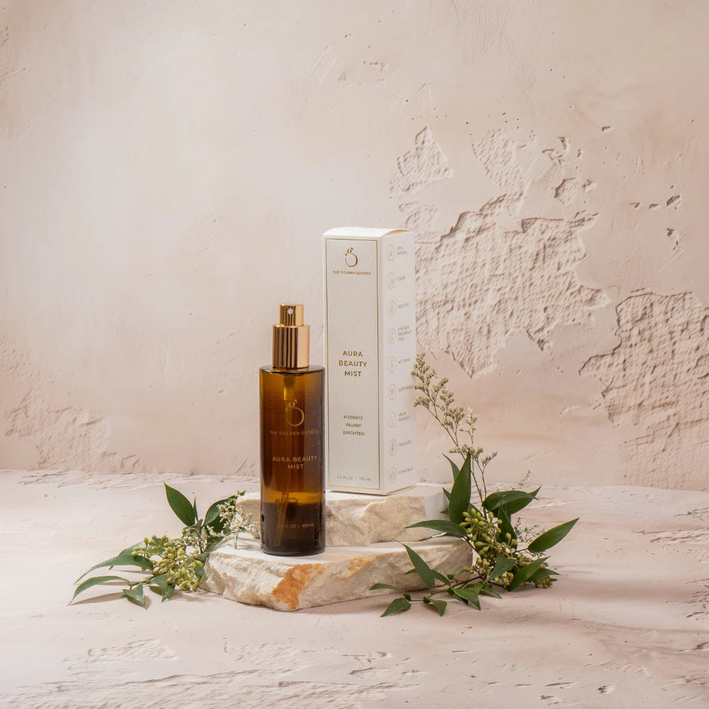 The Golden Secrets Aura Beauty Mist, a hydrating, plumping, and brightening facial mist that boosts skin radiance and soothes the senses. Formulated with key ingredients like tremella mushroom, red algae arctic peptide, and neroli orange blossom, it nourishes and protects the skin while enhancing hydration and balance. 30 ml