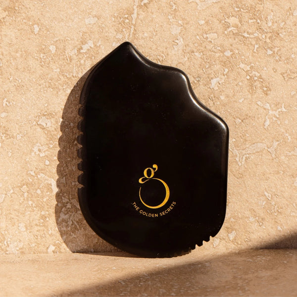 The Golden Secrets Sorceress Stone Gua Sha Beauty Tool, crafted from natural Sibin Bian stone, designed to enhance your skincare routine with over 40 trace elements.