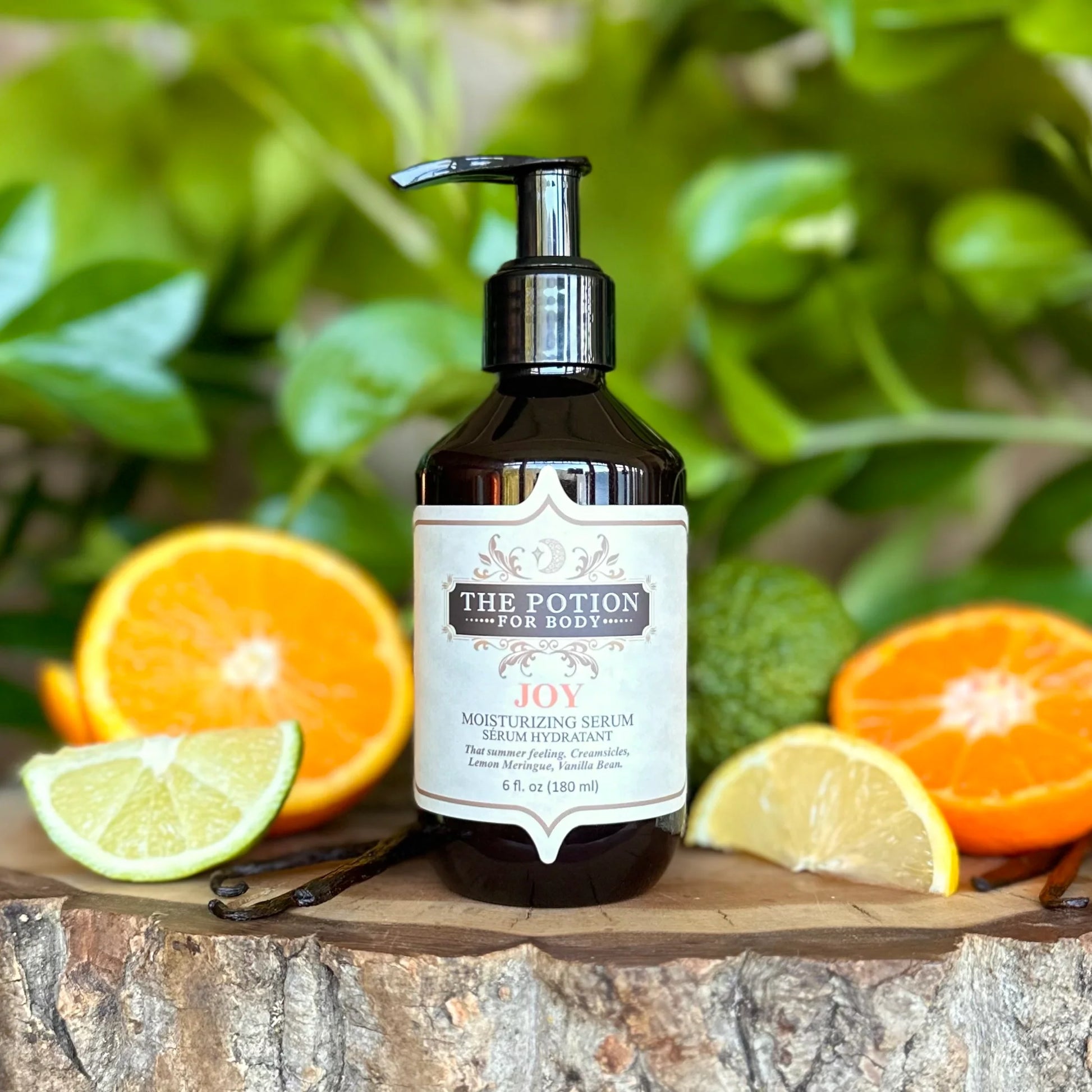 THE POTION COSMETICS Joy Moisturizing Serum bottle with citrus fruits and vanilla bean, evoking a fresh, summery glow.