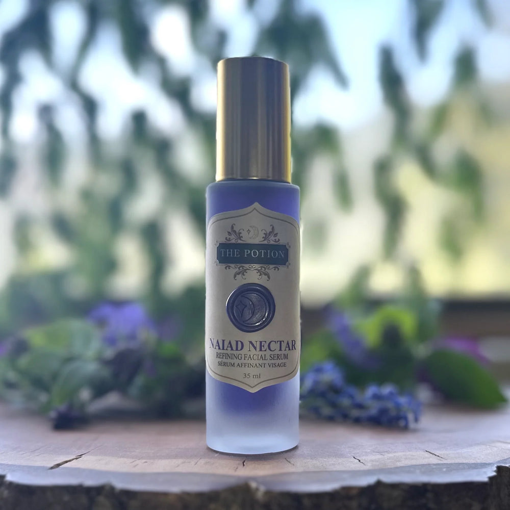 Facial serum bottle labeled 'Naiad Nectar' on a white background