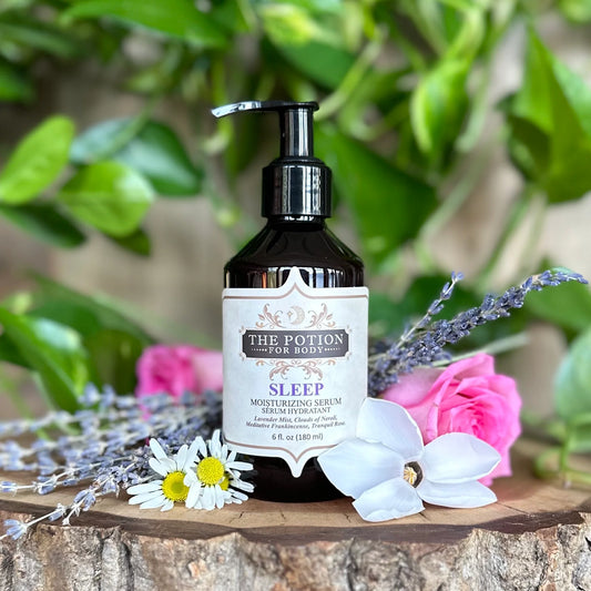 THE POTION COSMETICS Sleep Moisturizing Serum bottle surrounded by lavender, chamomile, and rose petals, evoking a calming nighttime ritual and soothing floral aroma.
