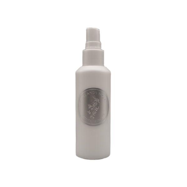 White spray bottle with a logo on a white background. TIDELANDS HOUSE Lilac Nectar Artisanal Copper Distillate