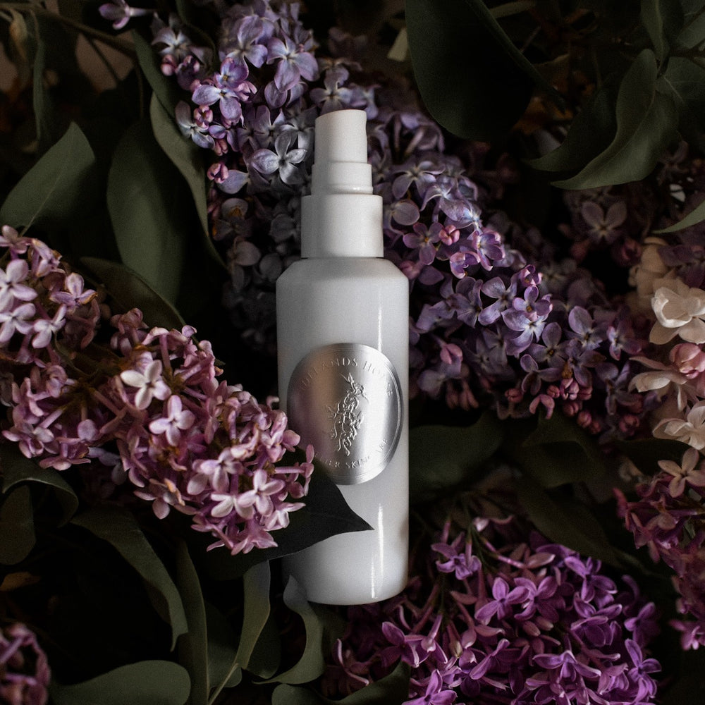 White spray bottle with a logo on a white background. TIDELANDS HOUSE Lilac Nectar Artisanal Copper Distillate