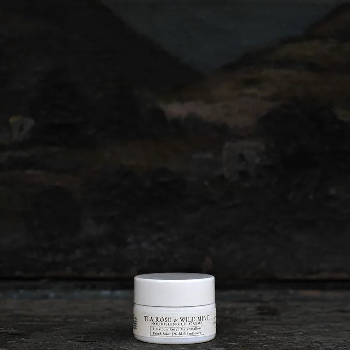 TIDELANDS HOUSE Tea Rose & Wild Mint Lip Crème in a sleek container, showcasing the creamy texture and botanical ingredients like Wild Tea Rose and Fresh Mint.