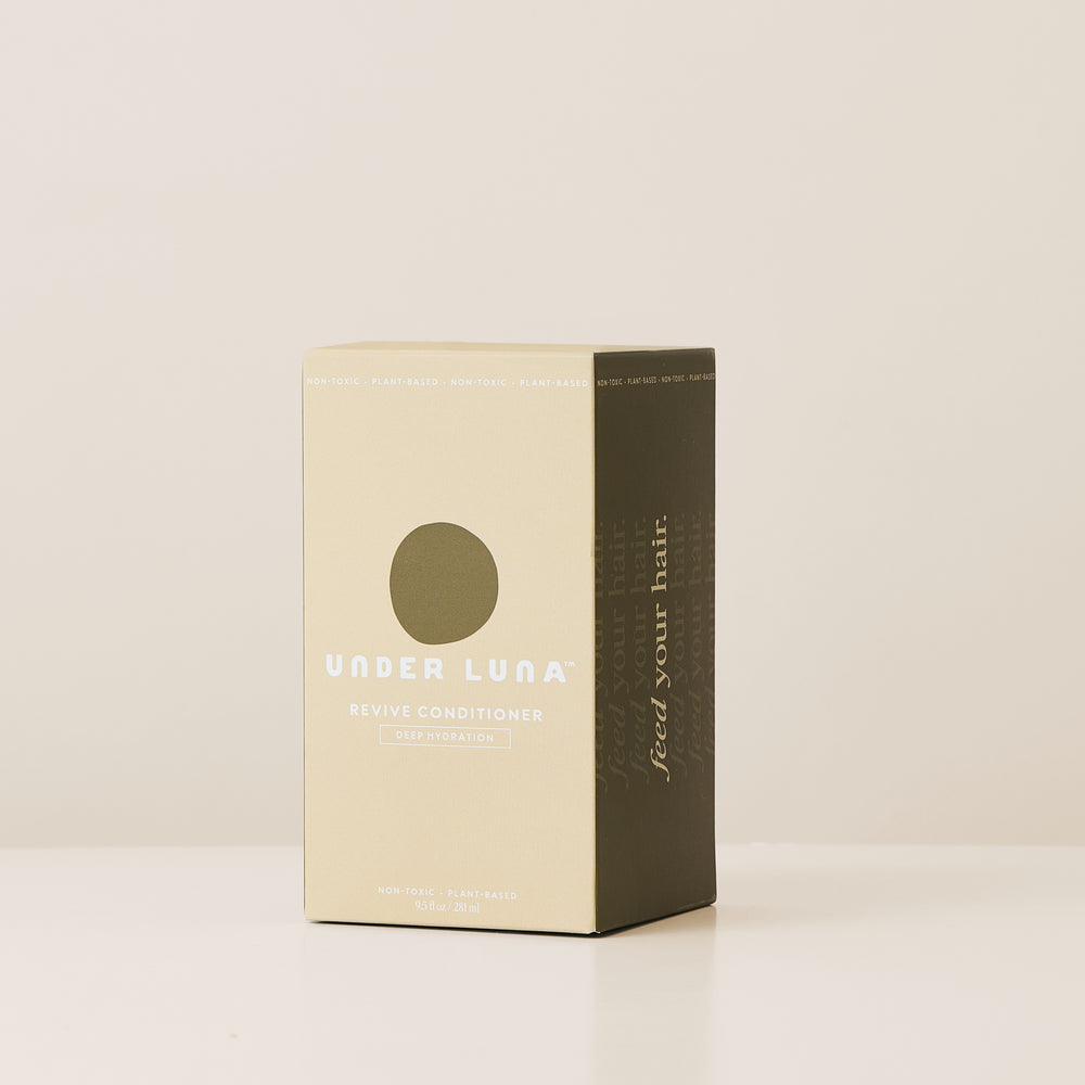 Under Luna Revive Conditioner in recyclable aluminum bottle, natural deep conditioner with jasmine and herbal extracts.