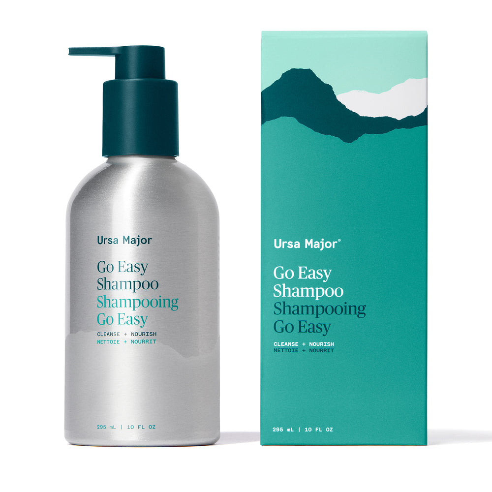 Bottle of Ursa Major Go Easy Shampoo – a sulfate-free, plant-based formula for soft, manageable hair with a warm woodsy scent of ginger, balsam, and fir.