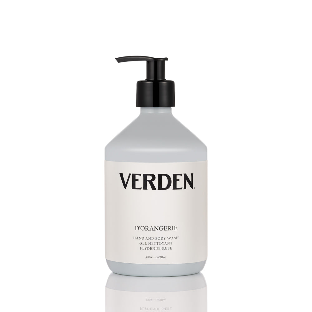 A bottle of Verden D'Orangerie hand and body wash with a black pump dispenser and a white label, set against a clean white background with a subtle reflection below.