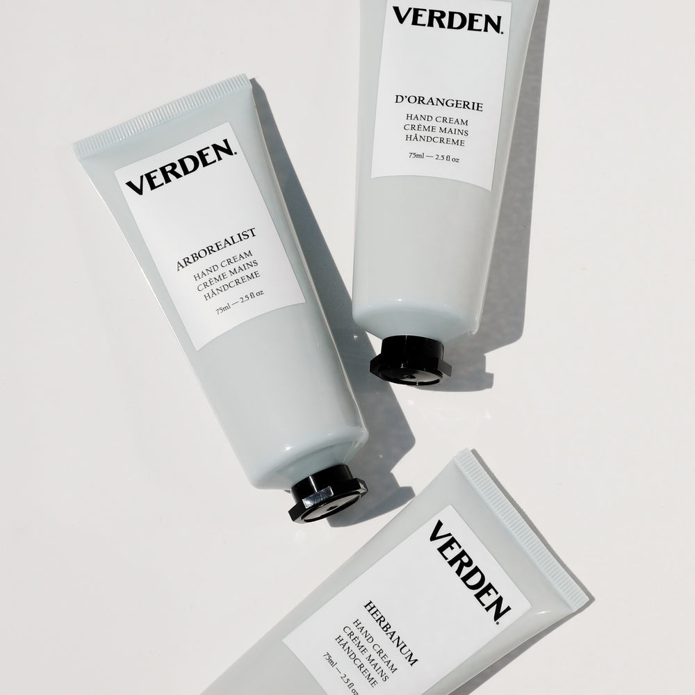 A silver squeeze tube of VERDEN Herbanum Hand Cream with a white label and black cap, centered on a white background.