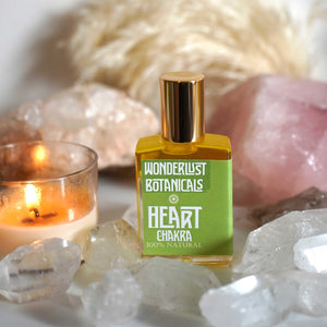 Wonderlust Botanicals Heart Chakra Perfume Oil - A floral blend of neroli, lavender, and citrus essential oils in a 0.5 oz roll-on bottle.