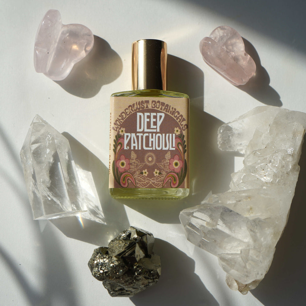 Wonderlust Botanicals Deep Patchouli Perfume Oil in a 0.5 oz roll-on bottle, featuring an earthy and woody fragrance.