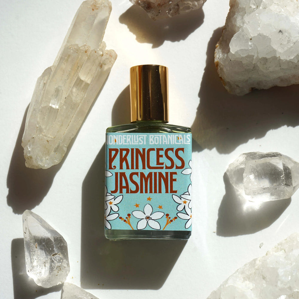 WONDERLUST BOTANICALS Princess Jasmine roll-on perfume in a 0.5 oz glass bottle, infused with pure jasmine essential oil for a warm, uplifting floral aroma.