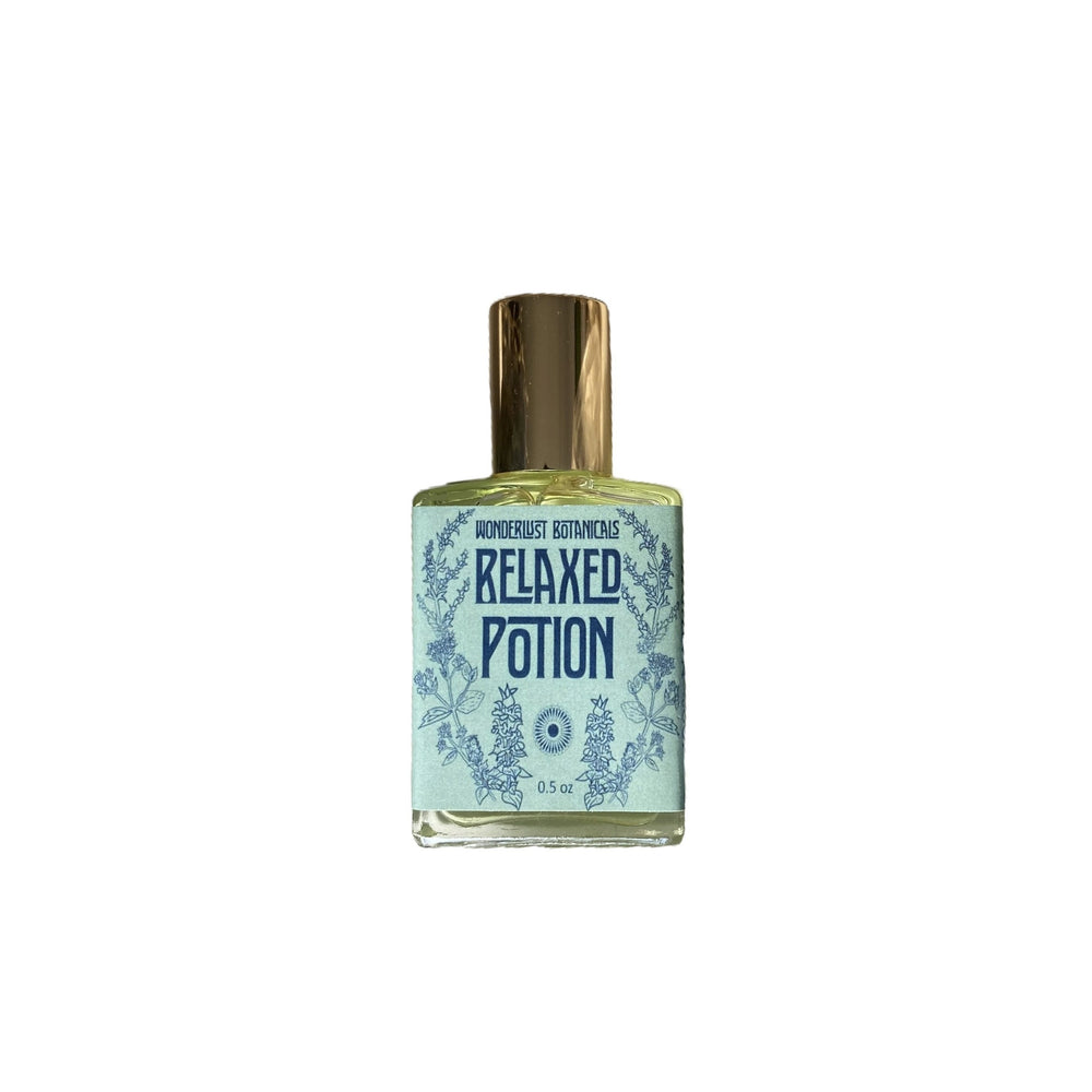 WONDERLUST BOTANICALS Relax Perfume Oil – A floral and herbaceous essential oil blend with a fresh, grounding aroma. Presented in a 0.5 oz roll-on glass bottle for easy application.