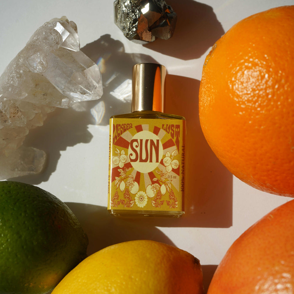 Wonderlust Botanicals Citrus & Patchouli Perfume Oil in a 0.5 oz roll-on bottle, offering a fresh and energizing blend of citrus and patchouli.