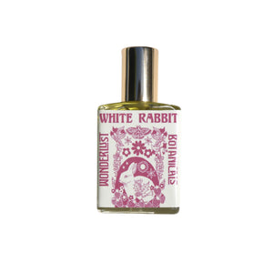 WONDERLUST BOTANICALS White Rabbit Aromatherapy Roll-On Perfume in a 0.5 oz glass bottle, featuring a fresh floral blend of patchouli, geranium, and bergamot essential oils.