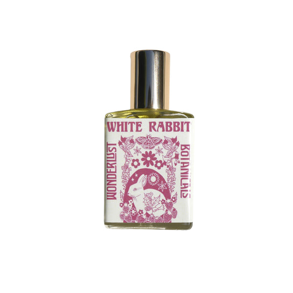 WONDERLUST BOTANICALS White Rabbit Aromatherapy Roll-On Perfume in a 0.5 oz glass bottle, featuring a fresh floral blend of patchouli, geranium, and bergamot essential oils.