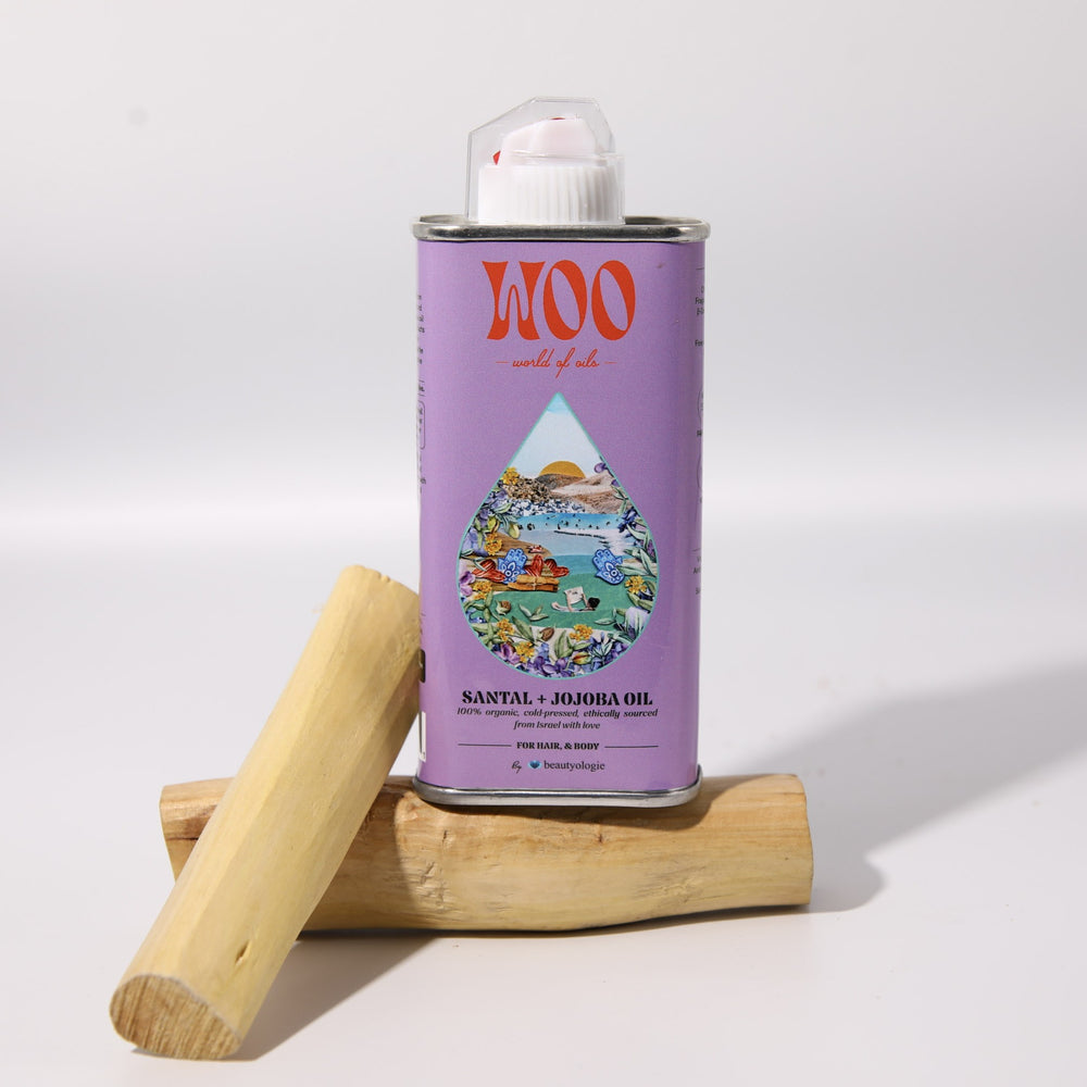 Lavender-colored can of WOO Santal + Jojoba Oil with a colorful label on a white background