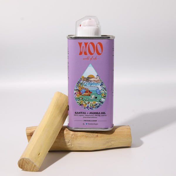 WOO Santal + Jojoba oil can with a wooden stick on a white background