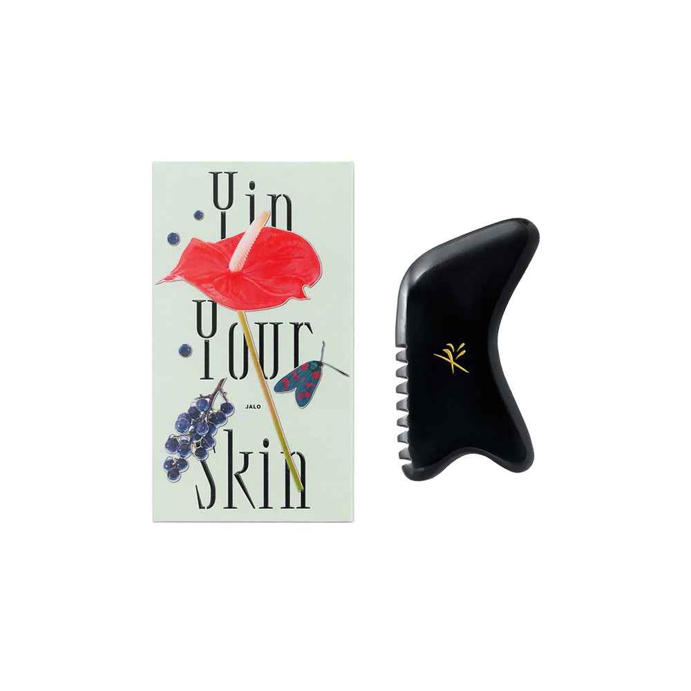 Yin Your Skin JALO Advanced Gua Sha Tool made of dark bian stone with serrated edge, U-notch, and hook-shaped end for facial massage.