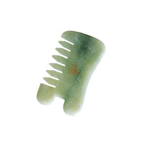 Green gua sha comb on a white background. YIN YOUR SKIN LOVI Gua Sha Comb